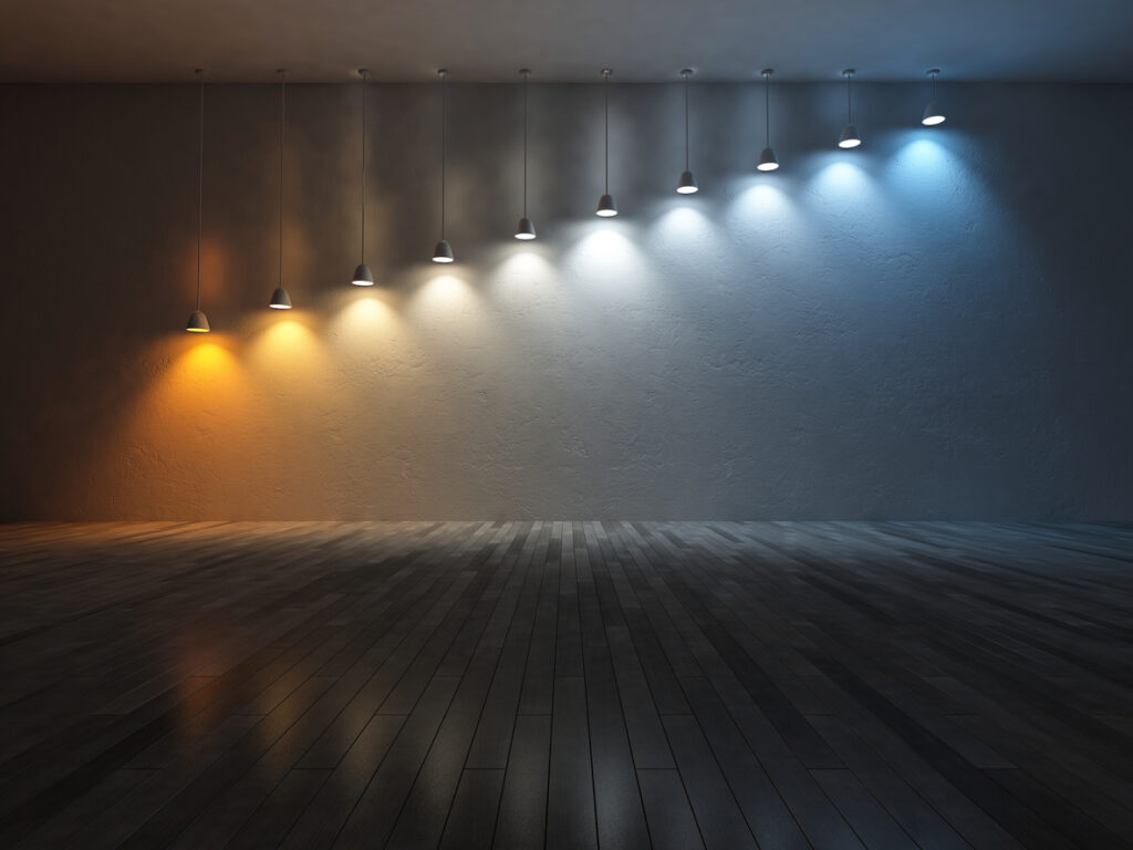 3D rendering image of 10 hanging lamps which use different bulbs. Color temperature scale. spectrum color on the cracked concrete wall and wooden floor