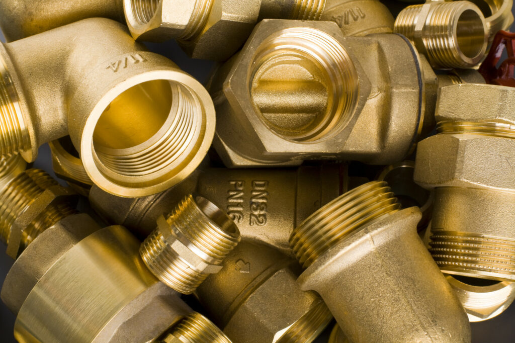 close up on pile of brass pipe fittings